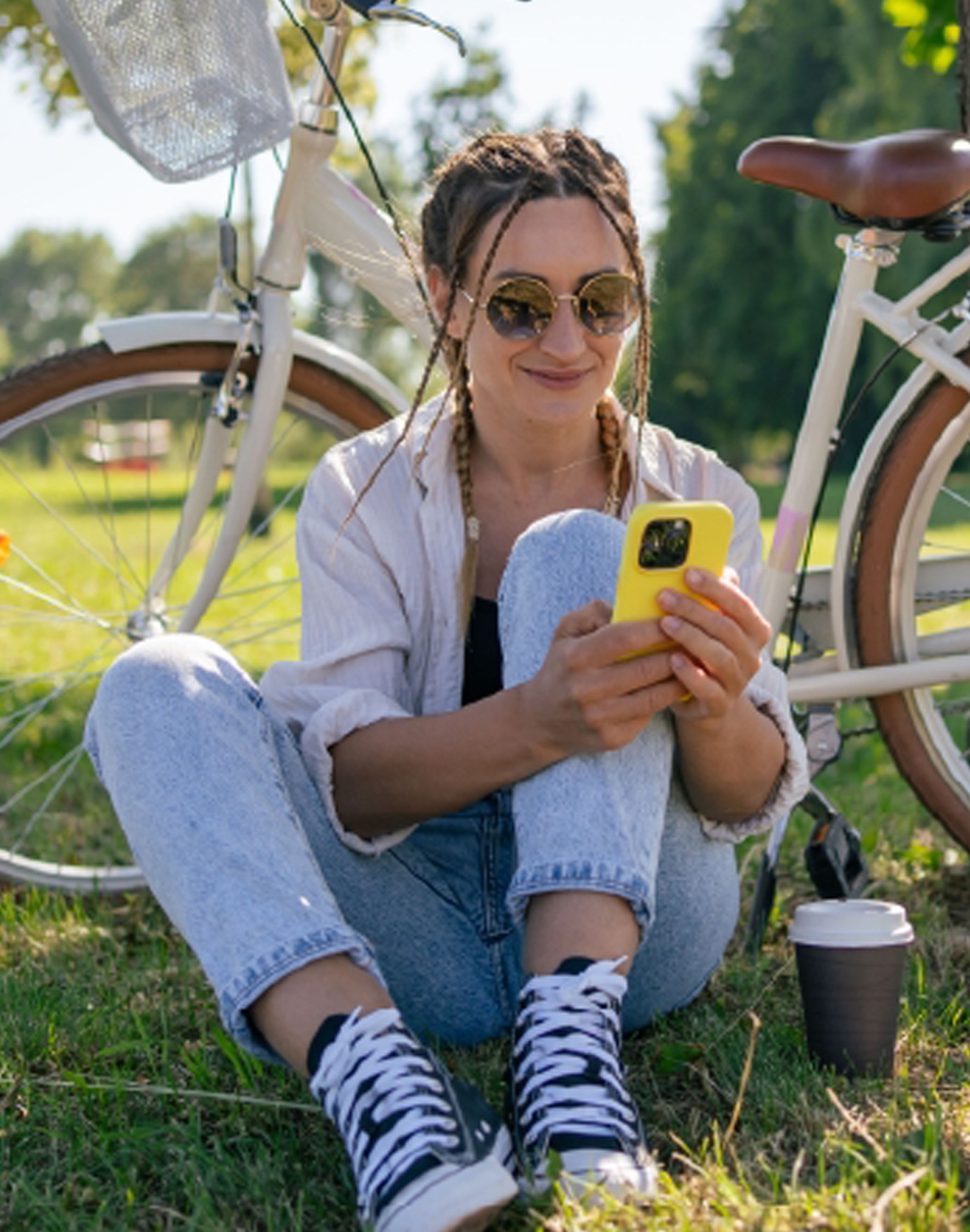 woman on a phone by a bike