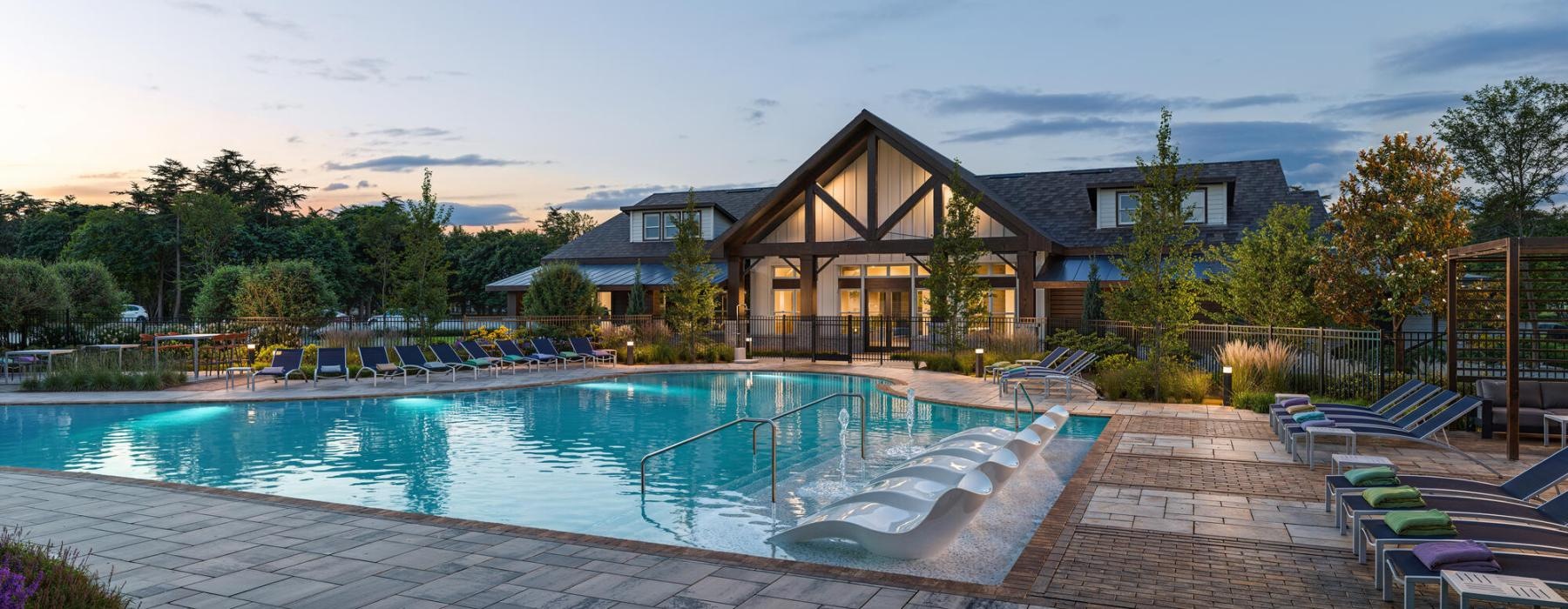 a swimming pool in front of a house